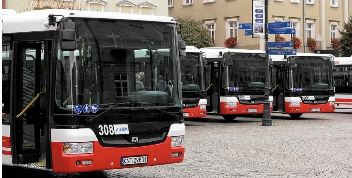 Czerwono-białe autobusy komunikacji miejskiej zaparkowane obok siebie 