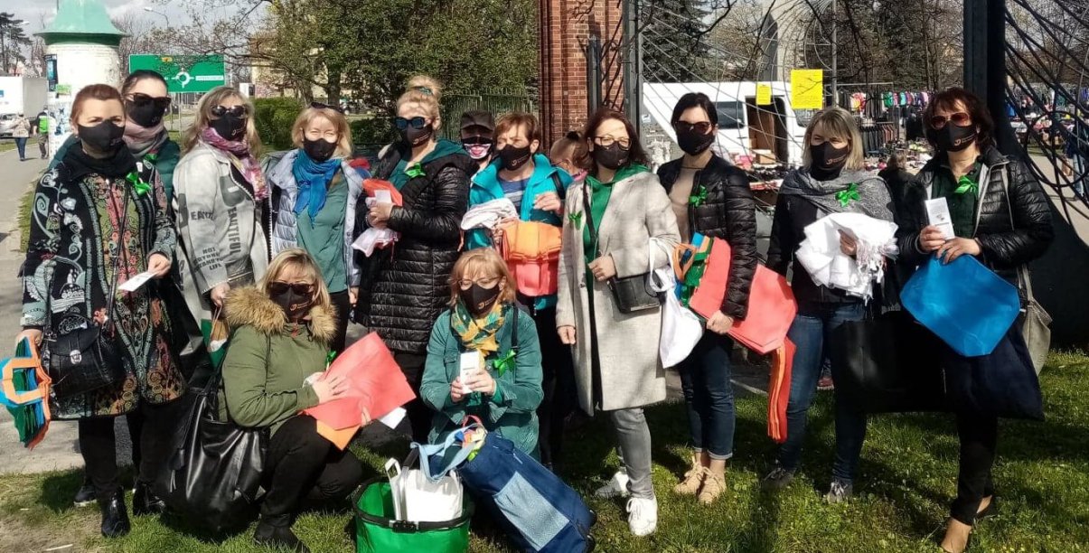 Kikanaście kobiet na wspólnym zdjęciu w maseczkach