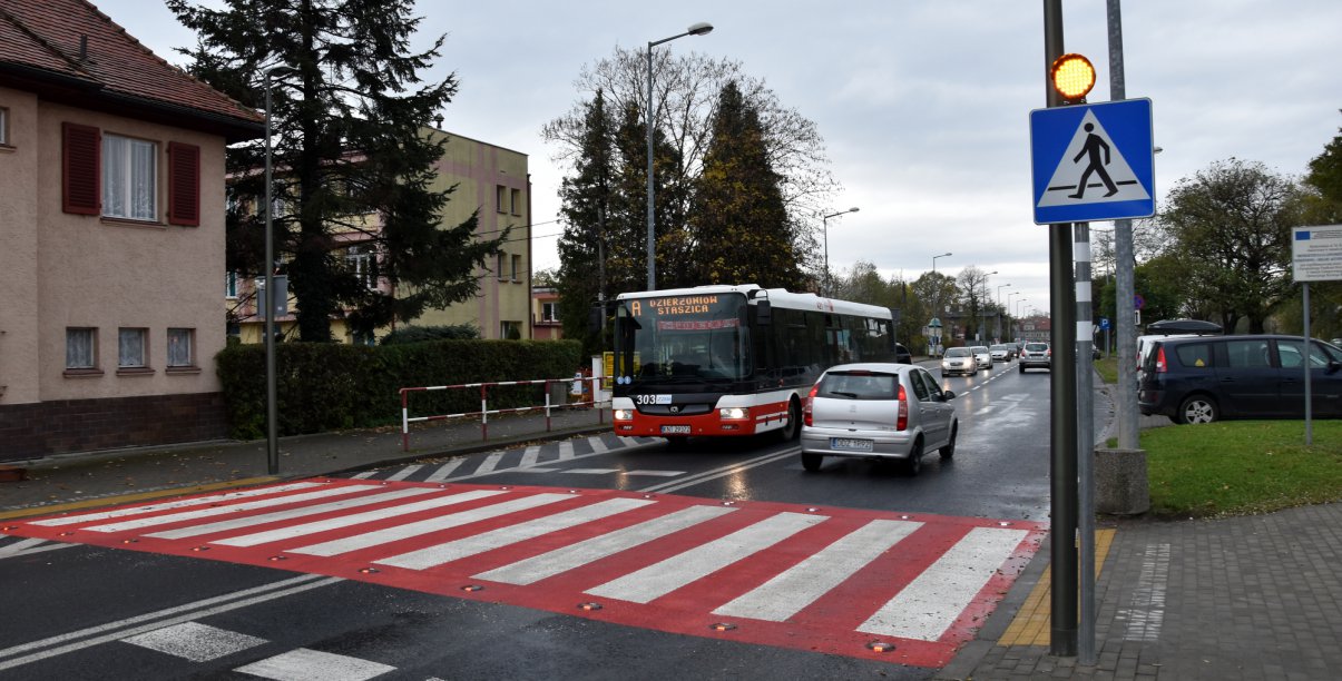 Przejśćie dla pieszych, autobus i auto stojące przed przejściem 