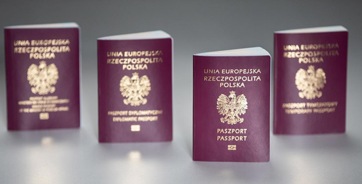 Cztery polskie paszporty, widok okładki, szare tło