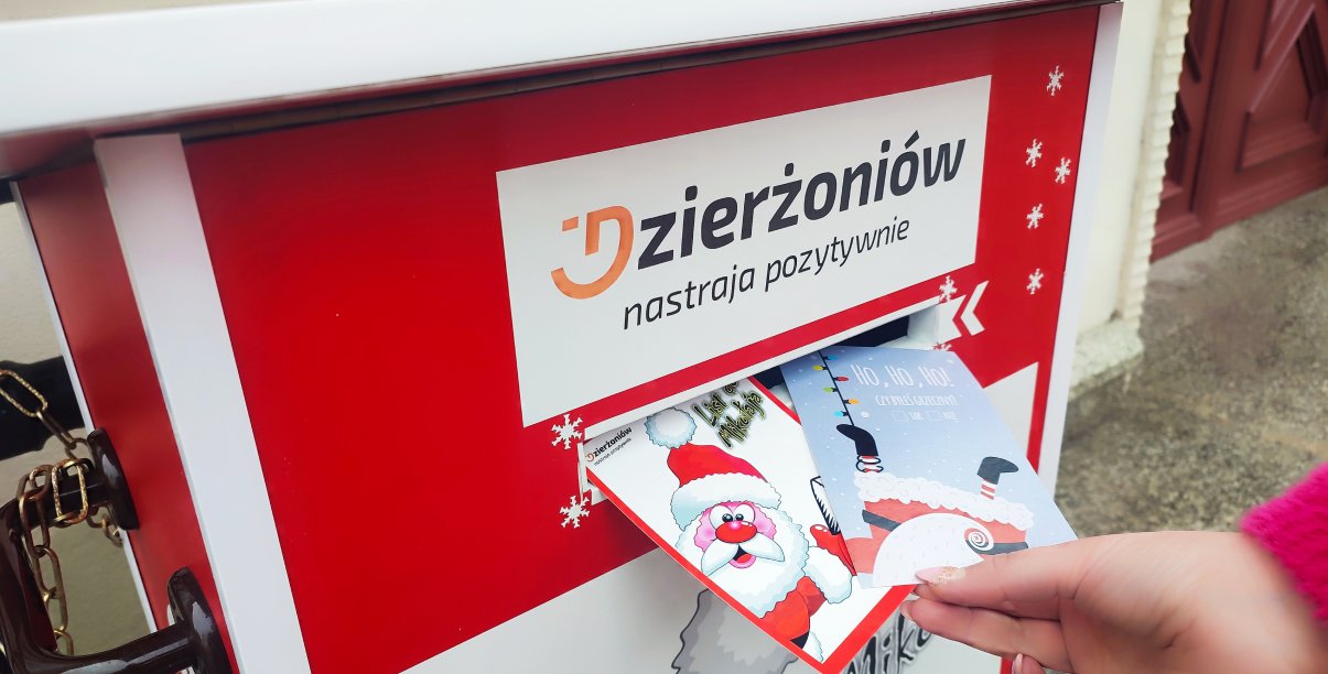 Czerwona skrzynka na listy i ręka wkładająća list, u góry napis Dzierżoniów