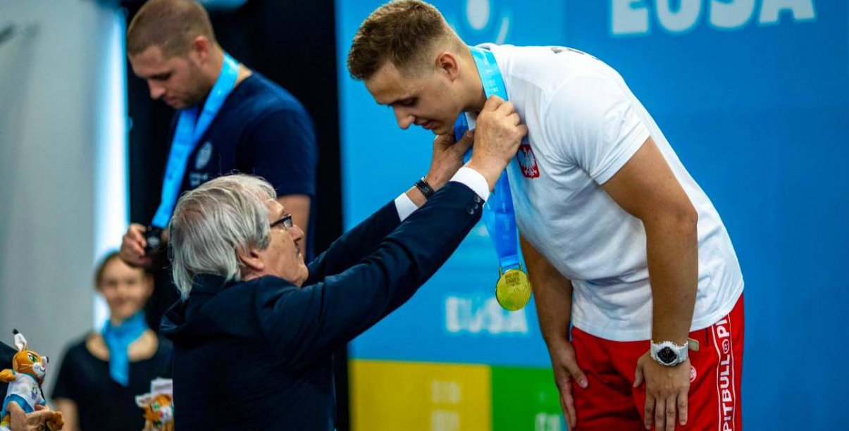 Zawodnik na podium przyjmuje złoty medal 
