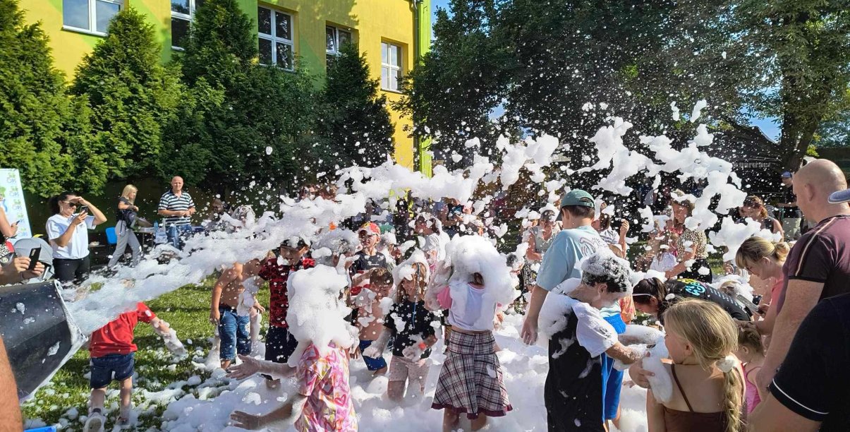 Grupa dzieci bawiąca się w pianie