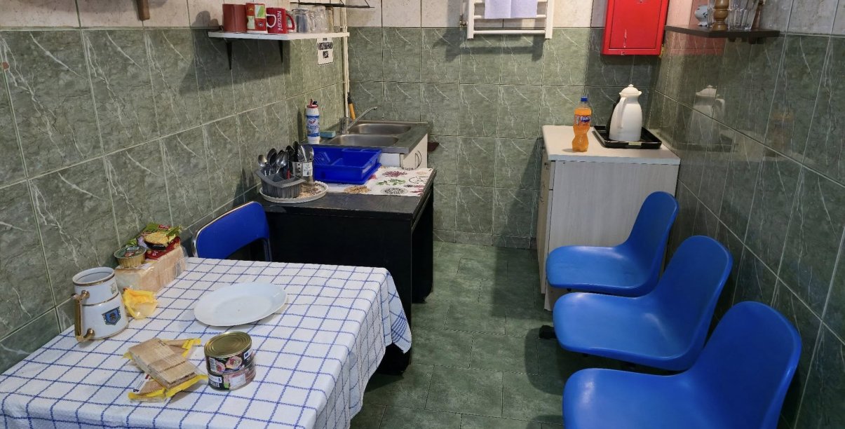 Pomieszczenie w dzierżoniowskiej ogrzewalni, stół kuchenny, krzesła, zlew