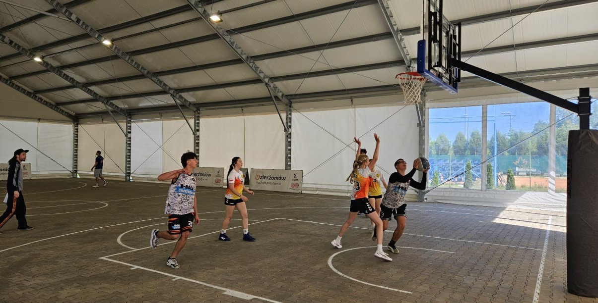 grupa młodziezy gra w koszta w hai namiotowej