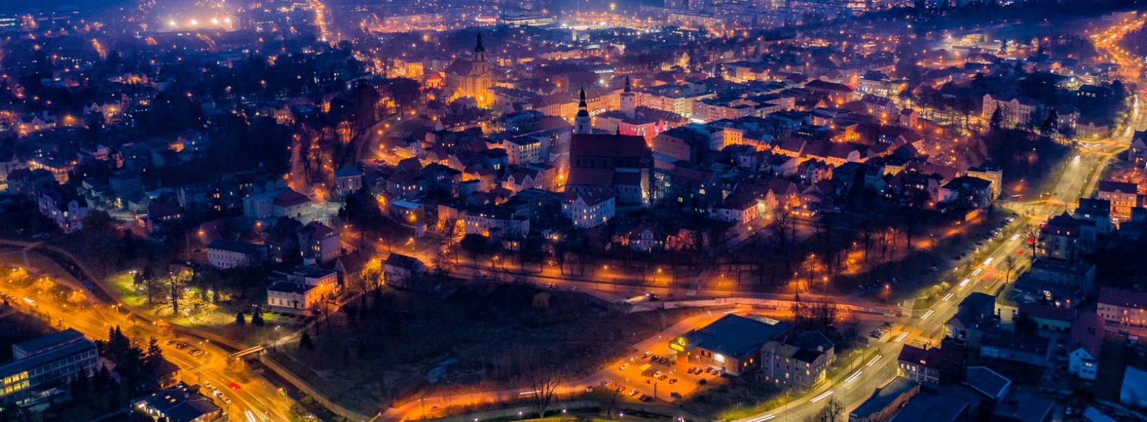 Dzierżoniów z góry nocą, na pierwszym planie oświetlone rondo