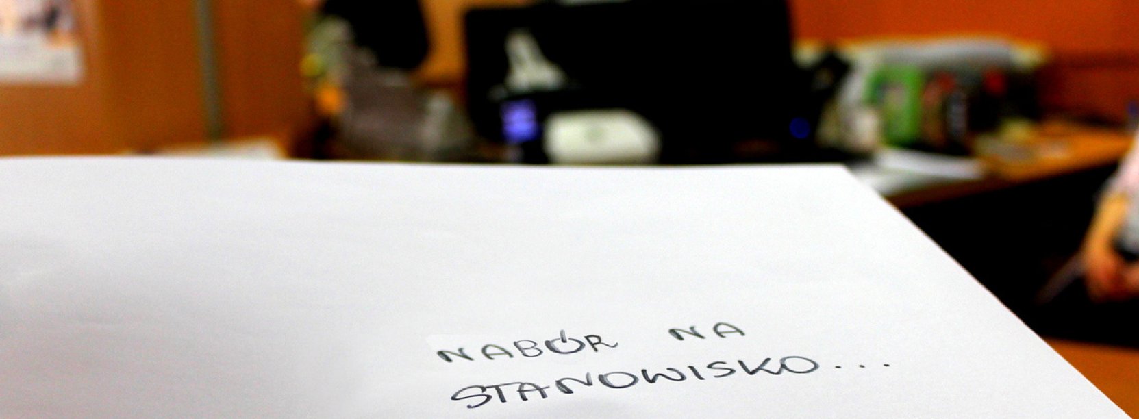 Dłoń trzymająca białą kopertę z napisem Nabór na stanowisko