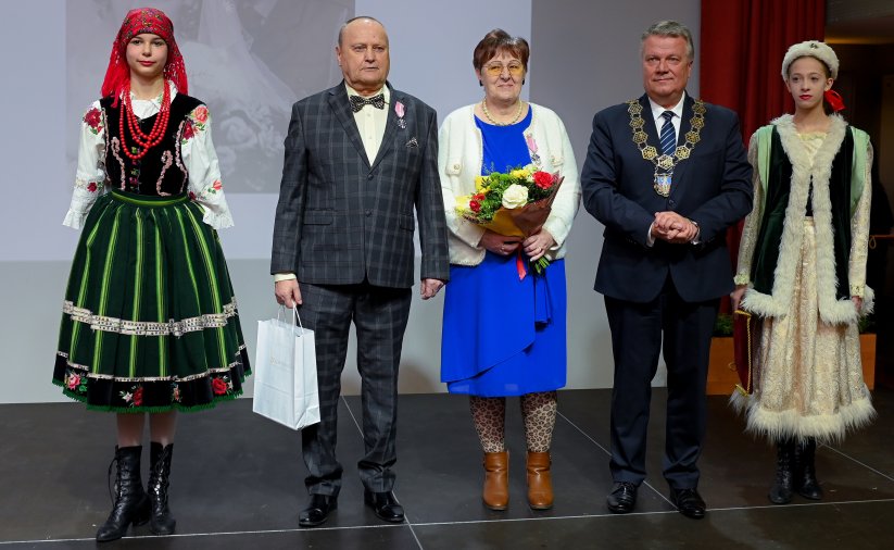 Para jubilatów z burmistrzem, po bokach dwie dziewczyny w strojach ludowych