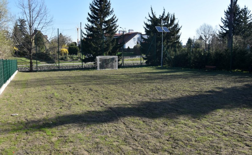 Trawiaste boisko piłkarskie ogrodzone płotem