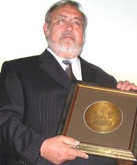 Hugo Berg trzymający w rękach duży medal