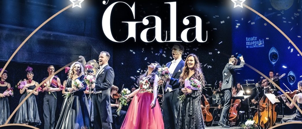 Duża scena wypełniona artystami trzymającymi w dłoniach kwiaty i napis Sylwestrowa Gala